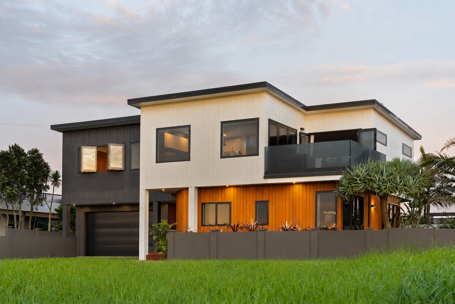Reclad two-storey coastal home with contrasting cladding